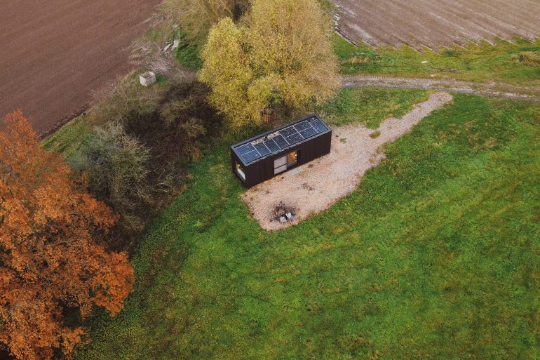 view from above of the slow cabin and fields surrounding it